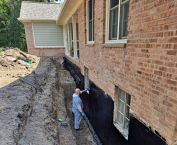 Excavated next to a foundation to expose the basement wall. Waterproofing installed and everything was backfilled.
