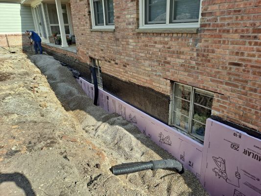Drain tile installed where window wells will be, to carry water away from the foundation