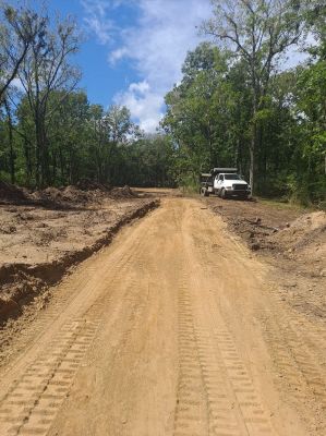 Installing a road to divide property into smaller lots. The base is critical and needs to be done correctly