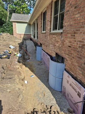 Foundation repair, window wells installed, insulation and backfill.