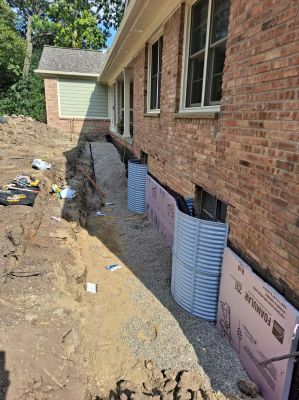 Foundation repair, window wells installed, insulation and backfill.